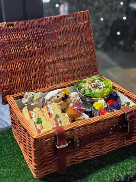 Afternoon tea basket with the lid open showing contents inside
